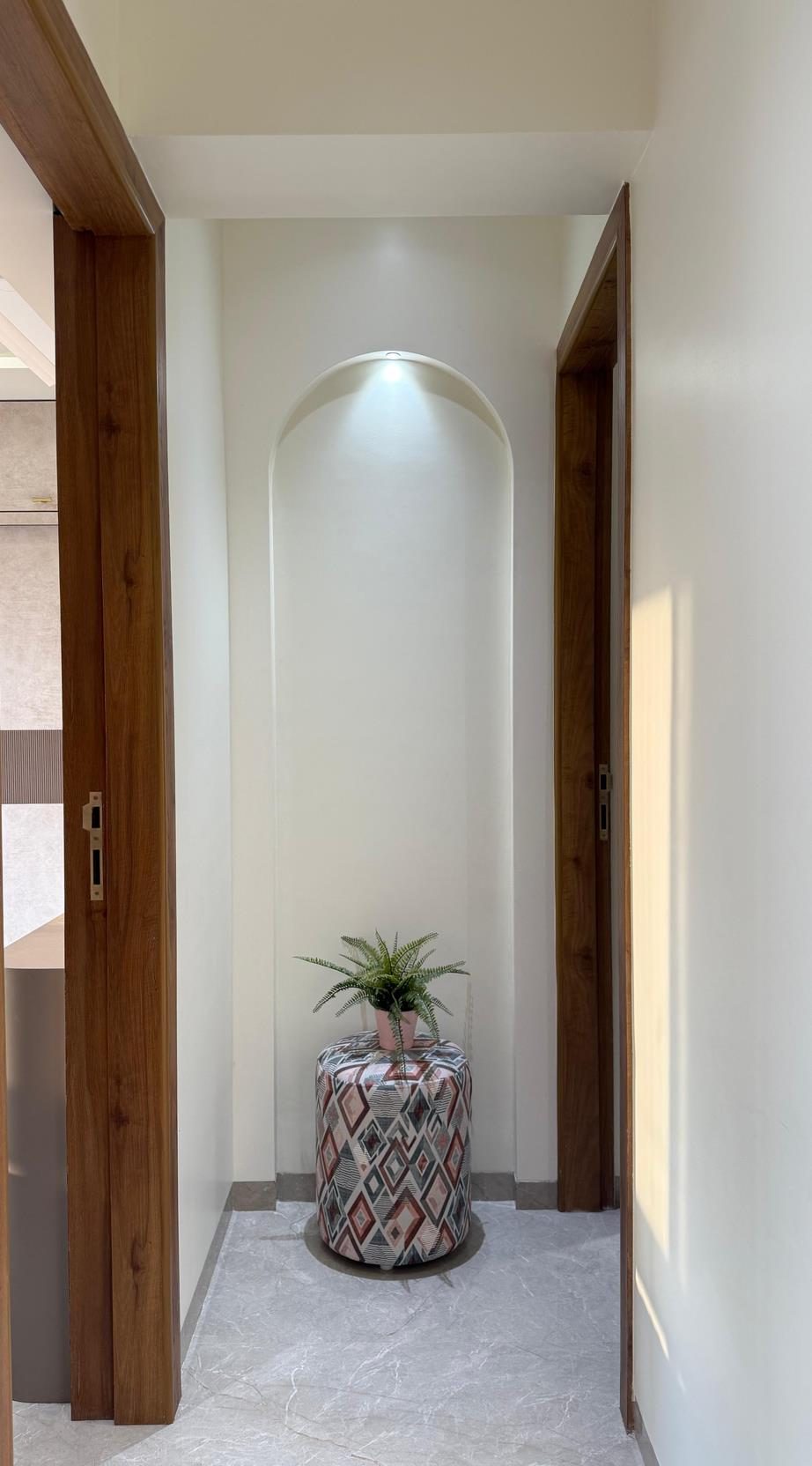 Arched walnut alcove with marble flooring — an interior detail by Urbanwall, led by Navi Mumbai architect Nabiya Naik.